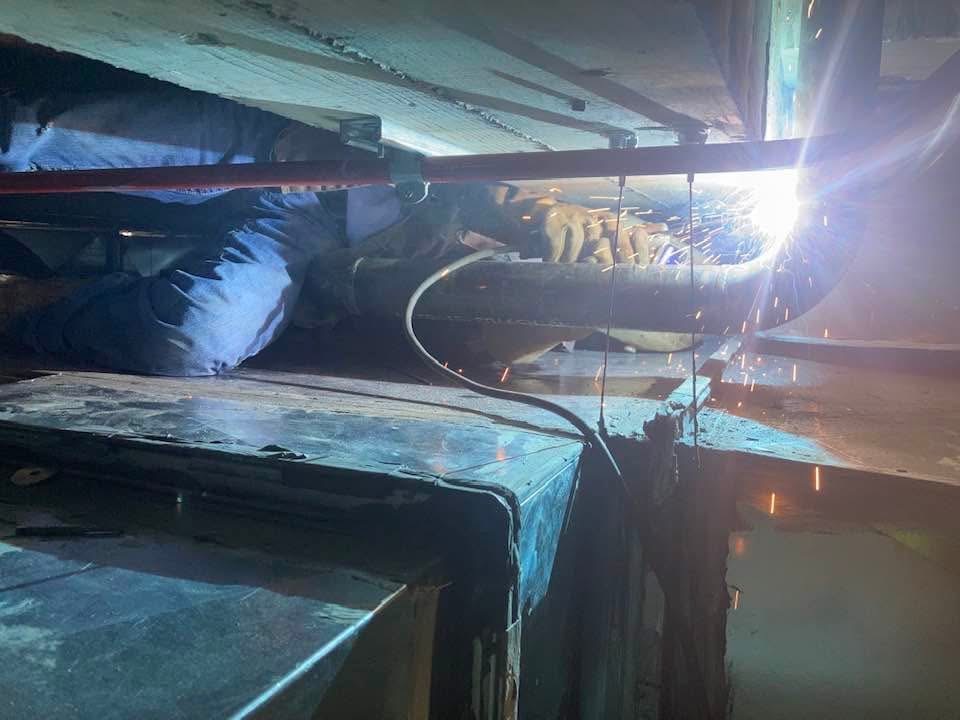 Overhead fabrication work inside an industrial facility