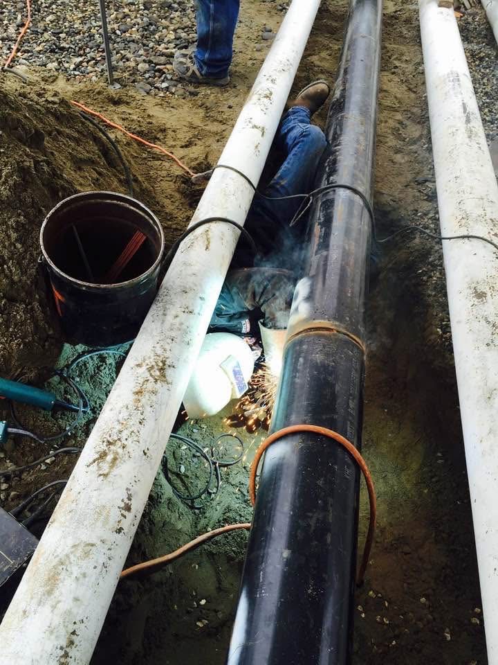 Crew working on process piping in the field