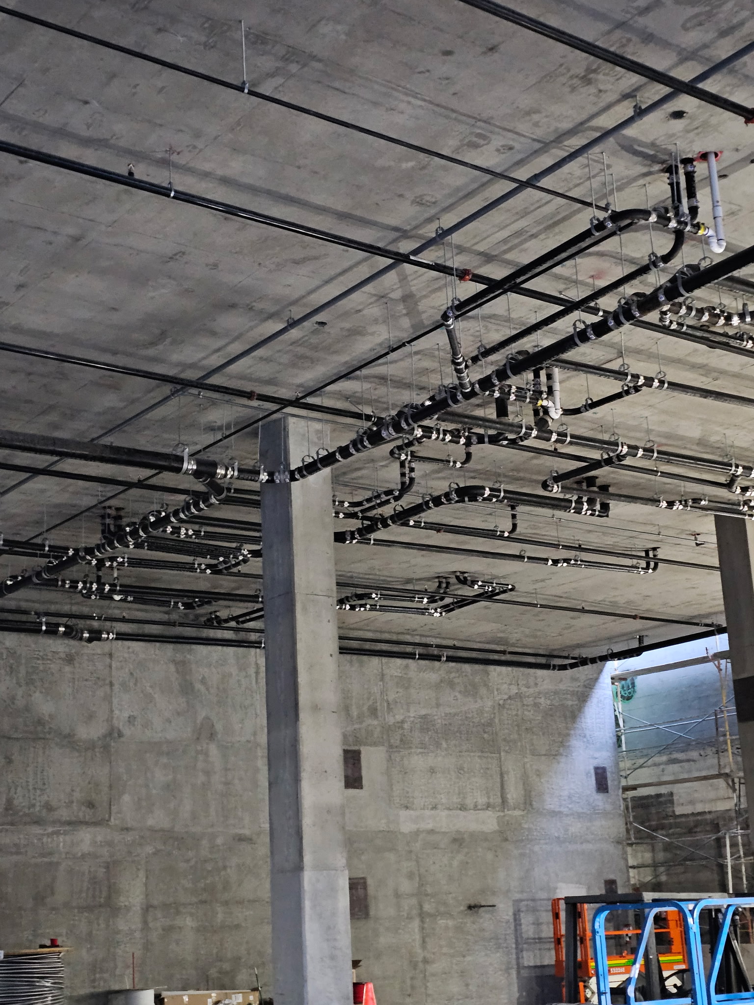 Overhead piping and systems installation inside a concrete structure
